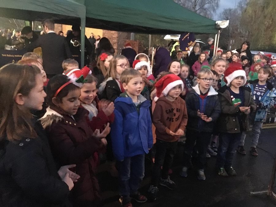 Here we are singing in the village square, before Father Christmas switched on the lights.